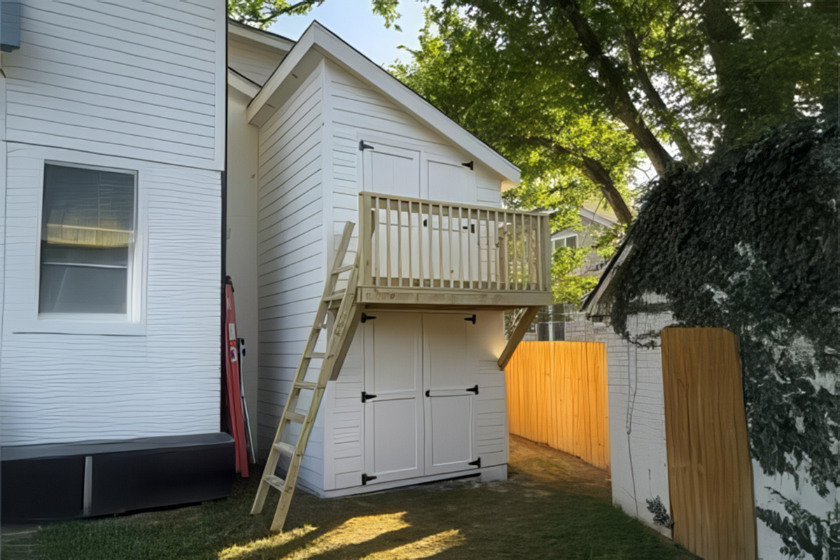 Custom studio with Hardie siding, sliding bard door, and transom windows